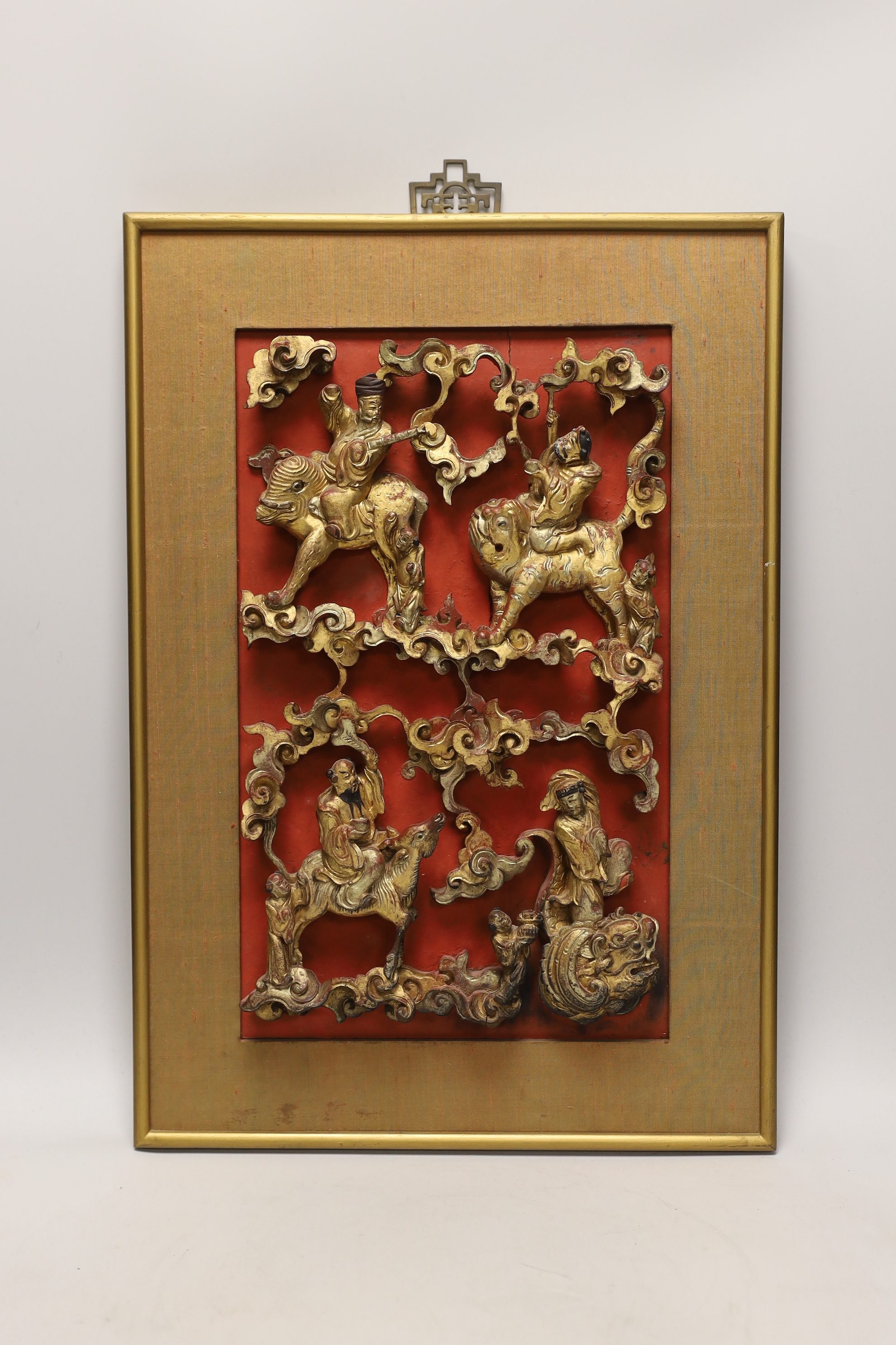 A Chinese framed gilded and lacquered wood panel, 35cm high, 22cm wide